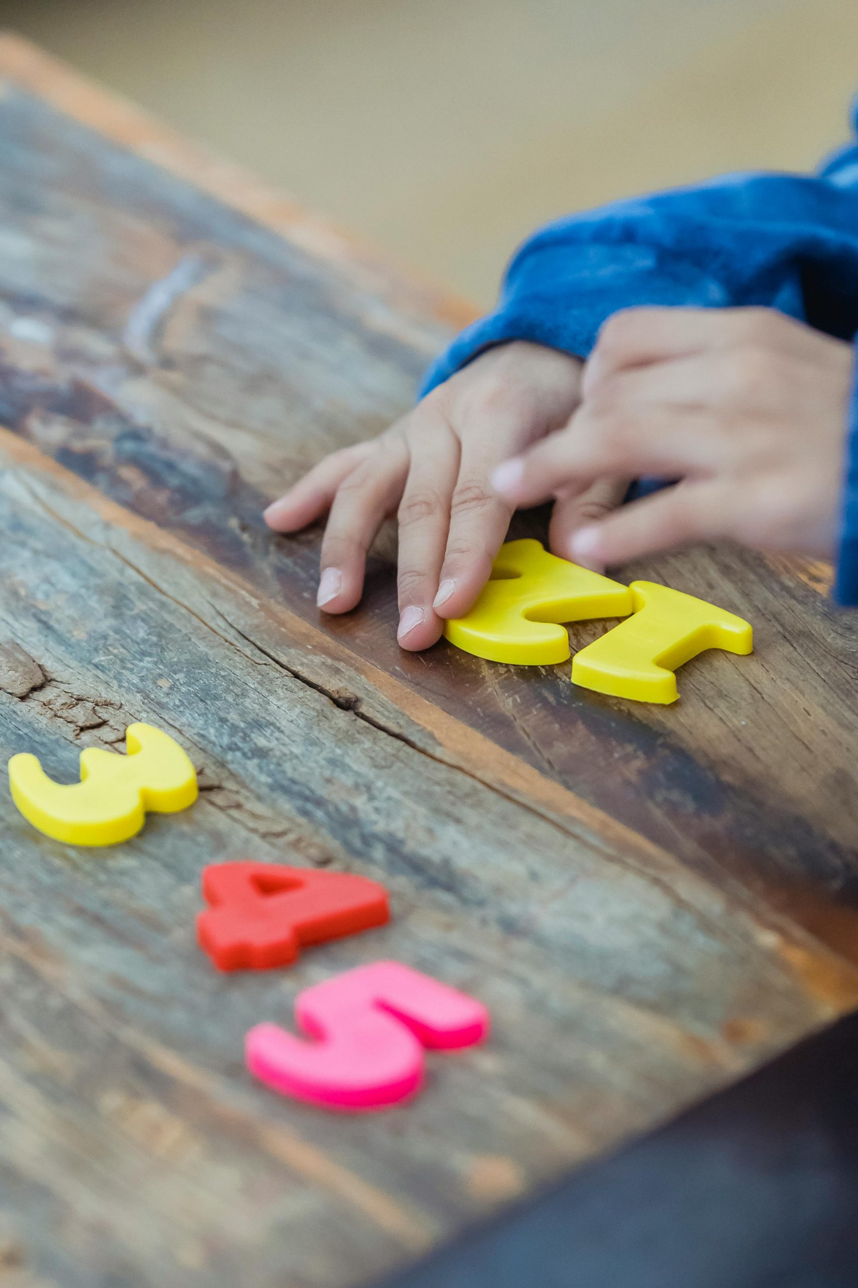Child playing with colorful numbers